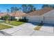 Exterior view of a two-story house with a two-car garage and well-maintained lawn at 5726 Autumn Shire Dr, Zephyrhills, FL 33541