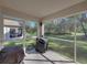 Screened porch with grill and view of backyard at 5726 Autumn Shire Dr, Zephyrhills, FL 33541