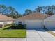 Daytime view of a single story home with garage at 5726 Autumn Shire Dr, Zephyrhills, FL 33541