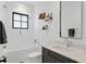 Well-lit bathroom featuring modern fixtures, sleek vanity, and tiled shower tub at 5811 Mariner St, Tampa, FL 33609
