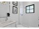 Bright, modern bathroom with sleek fixtures, marble counters, and a glass-enclosed shower at 5811 Mariner St, Tampa, FL 33609