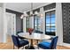 Elegant dining room with water views, stylish chandelier, and geometric wallpaper at 5811 Mariner St, Tampa, FL 33609