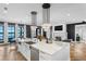 Stylish kitchen island with marble countertop, pendant lighting, and views into the living area and dining area at 5811 Mariner St, Tampa, FL 33609