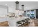Bright, modern kitchen features marble countertops, stainless steel appliances, and herringbone hardwood floors at 5811 Mariner St, Tampa, FL 33609