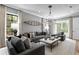 Bright and airy living room with large windows, stylish furnishings, and modern decor accents at 5811 Mariner St, Tampa, FL 33609