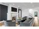 Cozy living room with fireplace, geometric accent wall, and comfortable seating at 5811 Mariner St, Tampa, FL 33609