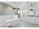 Spa-like main bathroom with a freestanding tub, glass-enclosed shower, and elegant fixtures at 5811 Mariner St, Tampa, FL 33609