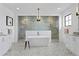 Spa-like main bathroom with a freestanding tub, glass-enclosed shower, and elegant fixtures at 5811 Mariner St, Tampa, FL 33609