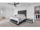 Bright main bedroom with a ceiling fan and a walk-in closet, offering a serene retreat at 5811 Mariner St, Tampa, FL 33609