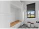 Mudroom features custom built-in storage with window and bench and modern decor at 5811 Mariner St, Tampa, FL 33609