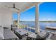 Relaxing covered patio featuring comfortable seating and a beautiful waterfront view at 5811 Mariner St, Tampa, FL 33609