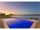 Rectangular pool with fire pit and waterfront view at sunset at 5811 Mariner St, Tampa, FL 33609