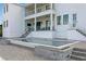 Beautiful home exterior featuring a modern swimming pool and covered patio with stairs at 5811 Mariner St, Tampa, FL 33609