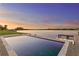 Waterfront pool and patio with fire pit offering a serene and luxurious outdoor experience at 5811 Mariner St, Tampa, FL 33609
