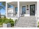Charming front porch featuring rocking chairs and well-maintained landscaping, creating an inviting entrance at 5811 Mariner St, Tampa, FL 33609
