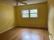 Bright bedroom with hardwood floors and double windows at 820 Virginia St # 207, Dunedin, FL 34698