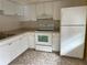 Efficient kitchen with white cabinets and appliances at 820 Virginia St # 207, Dunedin, FL 34698