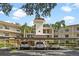 Front view of a two-story residential building with covered parking at 820 Virginia St # 207, Dunedin, FL 34698