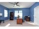 Home office with large desk, built in shelving and plenty of natural light at 8432 White Poplar Dr, Riverview, FL 33578