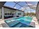 Enclosed pool and spa area with patio furniture and large screen TV at 10336 Wynward Way, Parrish, FL 34219