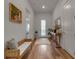 Light and bright entryway with wood floors, bench, and console table at 10336 Wynward Way, Parrish, FL 34219