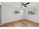 Well-lit bedroom with hardwood floors and two windows at 10721 64Th Ave, Seminole, FL 33772