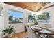 Bright dining area with wood-beamed ceiling and large windows at 10721 64Th Ave, Seminole, FL 33772