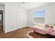 Well-lit bedroom featuring wood floors and ample closet space at 10836 Standing Stone Dr, Wimauma, FL 33598