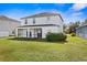 Two-story house with a screened patio and a spacious backyard at 10836 Standing Stone Dr, Wimauma, FL 33598
