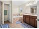 Elegant bathroom with a double vanity, garden tub, and separate shower at 10836 Standing Stone Dr, Wimauma, FL 33598