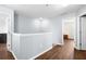 Upper hallway with wood flooring and access to bedrooms at 10836 Standing Stone Dr, Wimauma, FL 33598