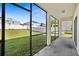 Screened porch overlooking a grassy backyard at 10836 Standing Stone Dr, Wimauma, FL 33598