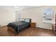Bright bedroom with wood flooring, a double bed, and ample closet space at 10836 Standing Stone Dr, Wimauma, FL 33598