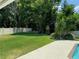 Spacious backyard with lush lawn and trees at 16501 Cranwood Pl, Tampa, FL 33618