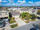Aerial view of a house and neighborhood with solar panels at 17036 Peaceful Valley Dr, Wimauma, FL 33598