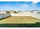 Large backyard with a grassy area and a privacy fence at 17036 Peaceful Valley Dr, Wimauma, FL 33598