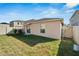 Spacious backyard with a large grassy area and privacy fence at 17036 Peaceful Valley Dr, Wimauma, FL 33598