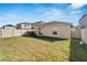 Spacious backyard with grassy area and a privacy fence at 17036 Peaceful Valley Dr, Wimauma, FL 33598