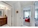 View of bathroom with sink and toilet with a door to another room at 17036 Peaceful Valley Dr, Wimauma, FL 33598