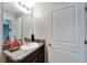 Small bathroom with sink and dark wood vanity at 17036 Peaceful Valley Dr, Wimauma, FL 33598
