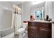 Simple bathroom with tub, shower, and dark wood vanity at 17036 Peaceful Valley Dr, Wimauma, FL 33598