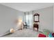 Charming bedroom with red couch, window, and floor lamp at 17036 Peaceful Valley Dr, Wimauma, FL 33598