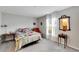 Bright bedroom with a queen-size bed and ample natural light at 17036 Peaceful Valley Dr, Wimauma, FL 33598