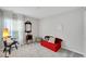 Bright bedroom with red couch, window, and antique furniture at 17036 Peaceful Valley Dr, Wimauma, FL 33598