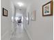 Hallway with tile flooring and artwork on the walls at 17036 Peaceful Valley Dr, Wimauma, FL 33598
