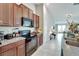 Modern kitchen with black appliances and ample counter space at 17036 Peaceful Valley Dr, Wimauma, FL 33598