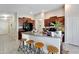 Kitchen with island, dark cabinets, and granite countertops at 17036 Peaceful Valley Dr, Wimauma, FL 33598