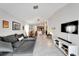 Spacious living room with sectional sofa and view of kitchen at 17036 Peaceful Valley Dr, Wimauma, FL 33598