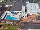 Aerial view of community pool with people swimming at 1715 S Pebble Beach Blvd, Sun City Center, FL 33573
