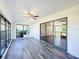 Bright sunroom with sliding glass doors and wood-look floors at 1715 S Pebble Beach Blvd, Sun City Center, FL 33573